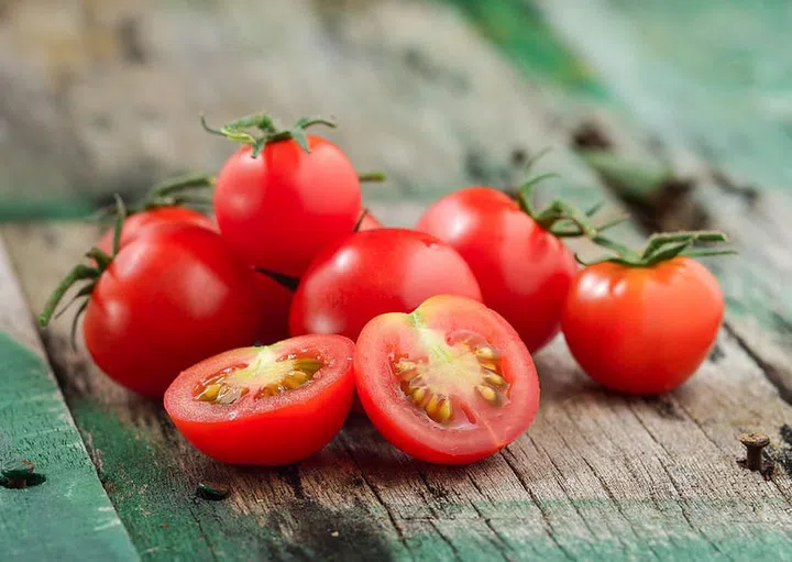 Close-up of fresh, ripe cherry tomatoes on wood