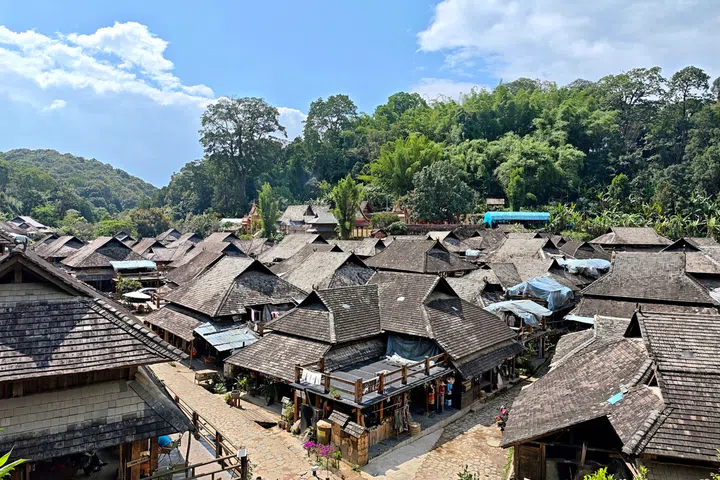 Nuogan Ancient Village, a traditional ancient Dai village located in the UNESCO World Heritage Jingmai Mountain Ancient Tea Forest area, Pu'er, Yunnan, China. The domestic poultry moves freely among traditional wooden stilt houses, ancient tea trees and rural pastoral scenery, presenting a simple and original rural ecological scene of Yunnan mountain villages.