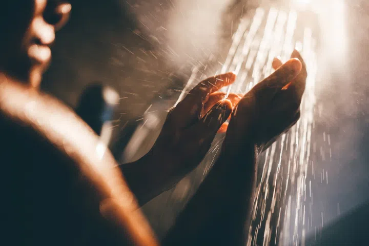 Woman taking a shower at home.