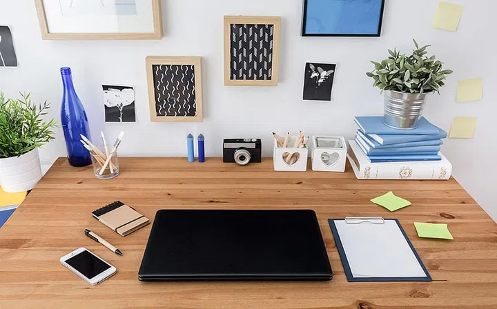 Laptop and mobile phone on wooden office table