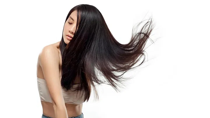 portrait of young asian woman with beautiful and healthy hair isolated on white