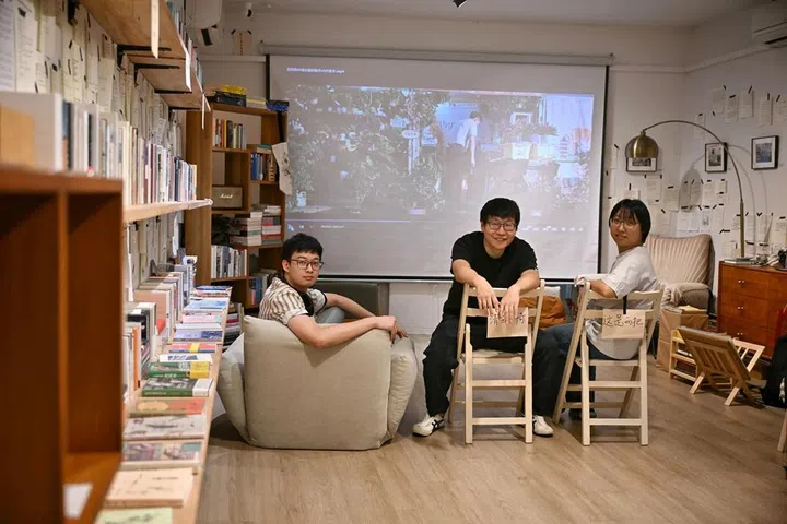 (From left) Volunter at TBC Bookstore, Haller Shen, 24, Owner of TBC Bookstore, Odie Wu, 42, and Store manager of TBC Bookstore, Xiaofei Yue, 36, on Dec 23, 2025.