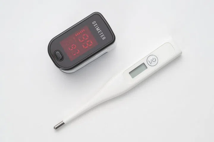 Top view of portable digital fingertip oximeter and thermometer