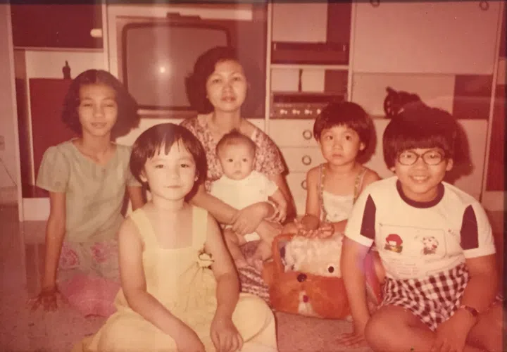 A family photo from 1978, showing singer Kit Chan (in yellow dress) and her mother, seated in the back.