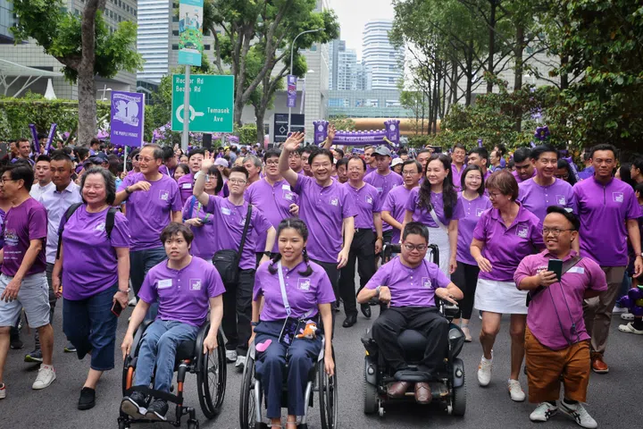 ST20231104_202335673442/syparade04/Shiying/Jason Quah DPM Lawrence Wong marches in the Purple Parade at Suntec City on Nov 4, 2023. He is accompanied by Ms Yip Pin Xiu (front middle in wheelchair), Co-Chairperson of The Purple Parade 2023 Organising Committee; Mr Maximilian Tan (front left in wheelchair), Member of The Purple Parade 2023 Organising Committee; Mr Alister Ong (front right in wheelchair), Vice-Chairperson of The Purple Parade Organising Committee; Ms Rachel Ong (5R), Adviser to The Purple Parade 2023; Ms Denise Phua (4R), Adviser to The Purple Parade 2023; Mr Johannes Cheong (left of dpm, raising arms), Member of The Purple Parade 2023 Organising Committee; Mr Tan See Leng, Manpower Minister (3L) ST PHOTO: JASON QUAH