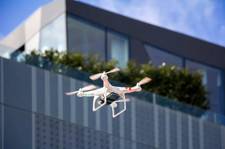 Radio controlled quadcopter drone flying in the city