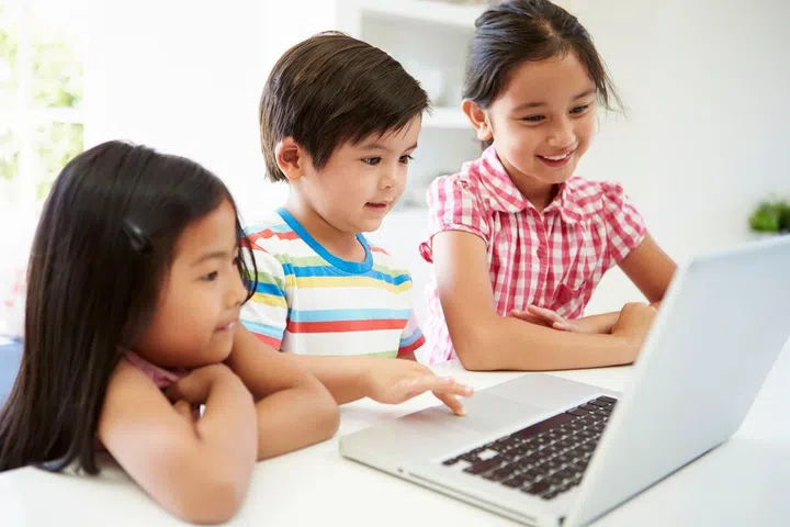 Three Asian Children Using Laptop At Home