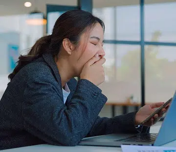 woman working and yawning