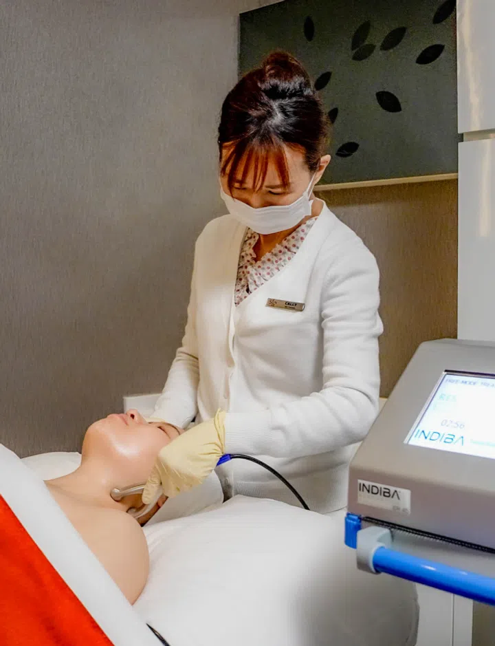 A facial therapist performs the Senze Indermis FaceLift Facial at Senze Boutique Spa 