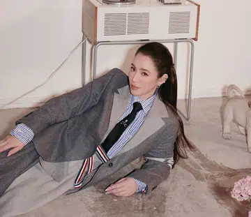 Arissa Cheo, founder of Romi Beauty, in a ponytail wearing a grey blazer, skirt and tie for the September Cover of Her World magazine