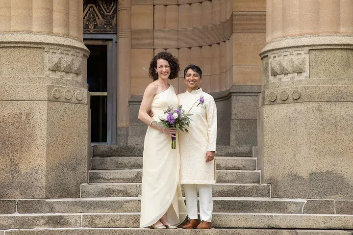 Editor and writer Mrigaa Sethi with their wife, Erin, on their wedding day in New York.