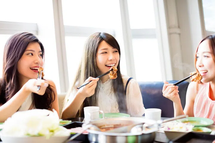 happy young Women group  Eating hot pot
