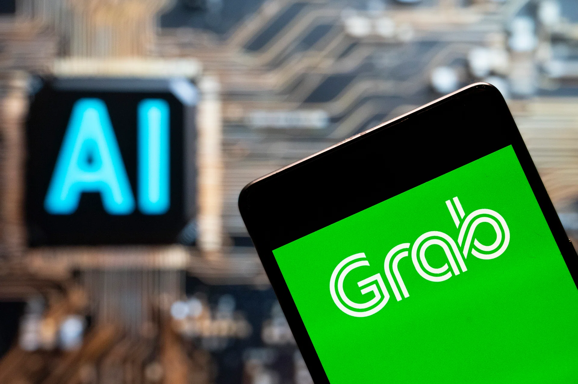 CHINA - 2023/11/03: In this photo illustration, the Singapore technology ride-sharing and food delivery service company Grab Taxi logo seen displayed on a smartphone with an Artificial intelligence (AI) chip and symbol in the background. (Photo Illustration by Budrul Chukrut/SOPA Images/LightRocket via Getty Images)