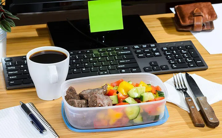 homemade lunch box at modern stylish work place, view from above