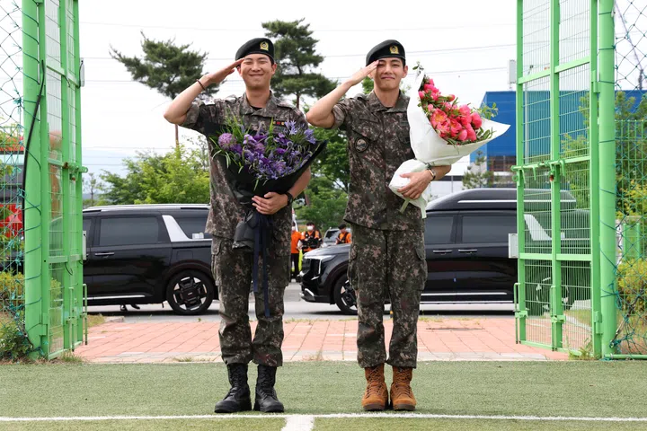 CHUNCHEON, SOUTH KOREA - JUNE 10: K-pop band BTS's members RM (L) and V (R) salute after being discharged from a mandatory military service on June 10, 2025 in Chuncheon, South Korea. Four members of the K-pop group BTS's RM, V, Jimin and Jungkook will be discharged from their mandatory 18-month military service next week, the boy band's agency said. RM, the leader of the group, and V completed the 18-month mandatory military service, which is required for all able-bodied male citizens in South Korea before they turn 28, followed by Jimin and Jungkook the next day, according to BigHit Music. (Photo by Chung Sung-Jun/Getty Images)
