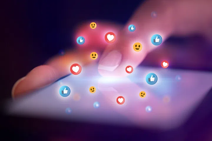 Finger touching phone with social media concept and dark background