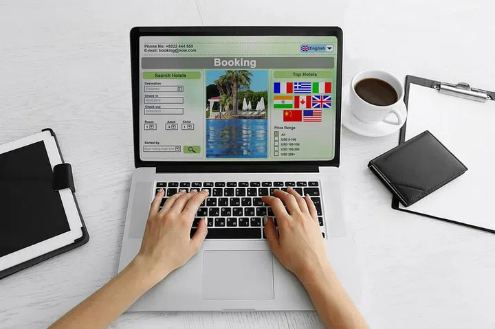 Woman using laptop to book hotel online