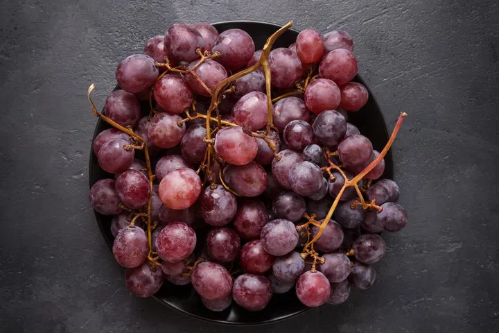 Grapes on a dark stone table. Fresh grape on black background. Copy space.