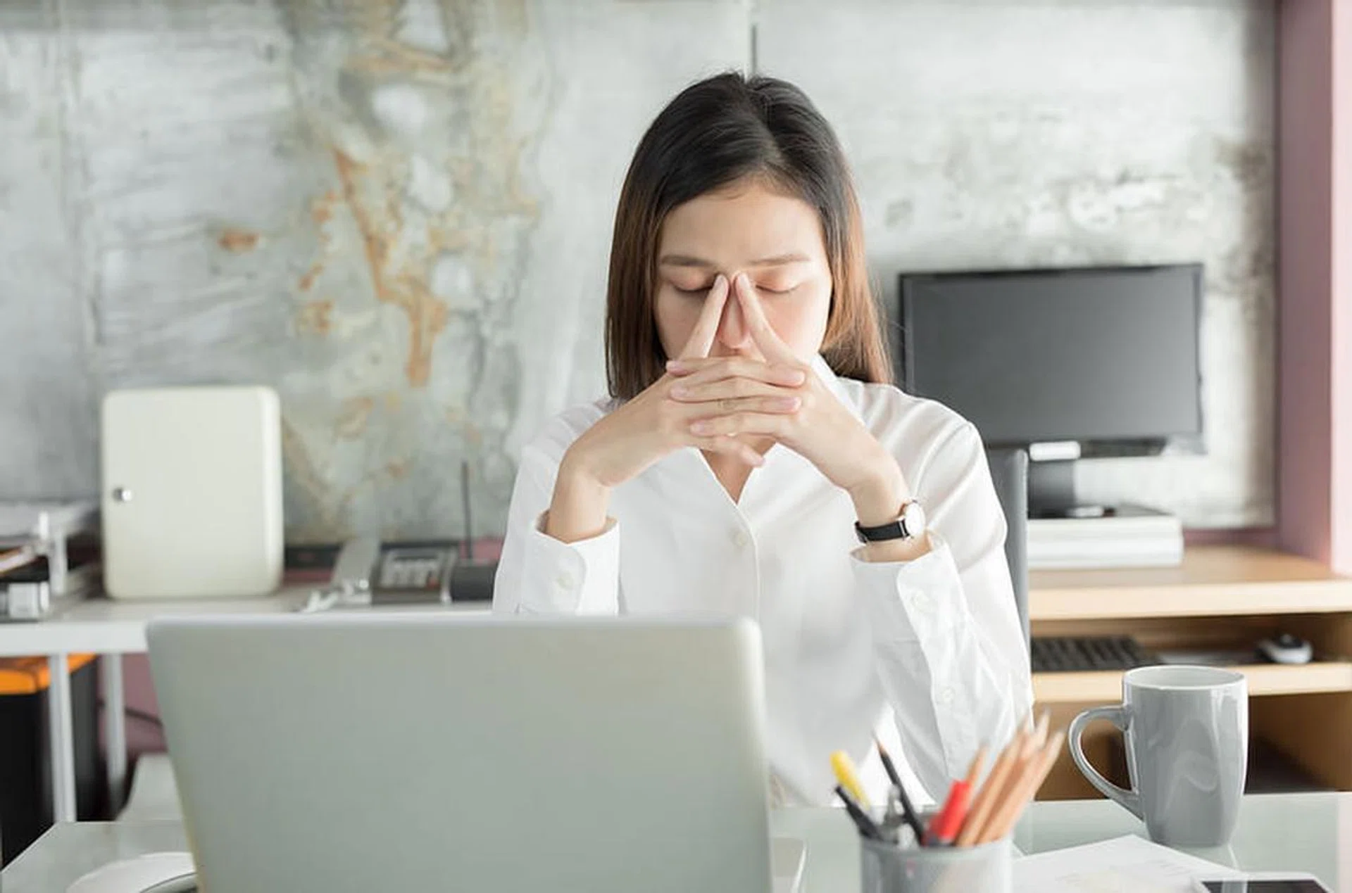 Young business people are suffering from headaches,Asian women Stressful Working with a notebook for a long time,Office syndrome concept