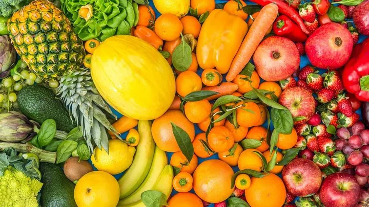 Colorful mix of fruits and vegetables background - Assortment of fresh and natural food sorted by color