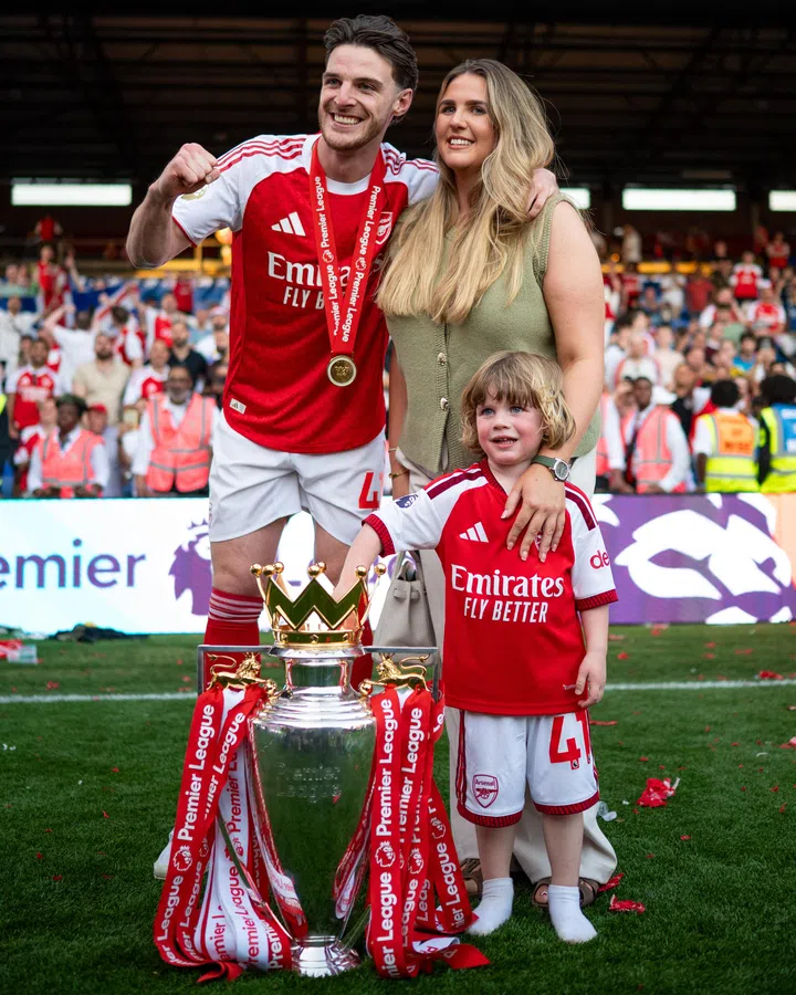 LONDON, ENGLAND Declan Rice of Arsenal poses with his wife Lauren and son Jude beside the Trophy during the Premier League match between Crystal Palace and Arsenal at Selhurst Park on May 24, 2026 in London, United Kingdom. (Photo by Sebastian Frej/Getty Images)