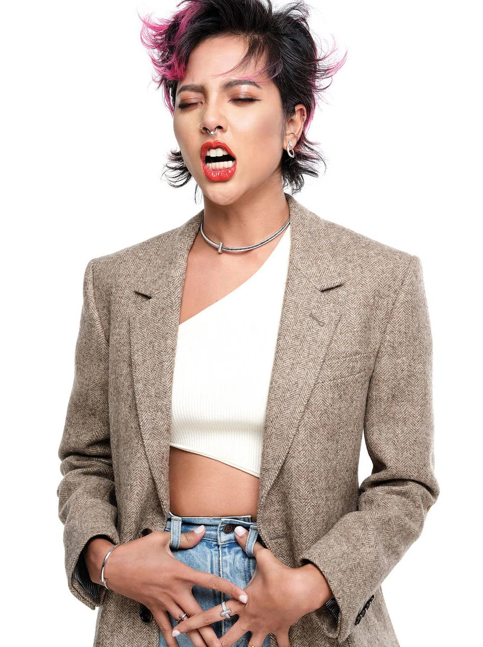 Wool jacket, knit bodysuit, and denim jeans, Celine. Tiffany T1 white gold and diamond open hoop earrings, Tiffany T1 white gold and diamond necklace, (on right hand) Tiffany T1 white gold and diamond narrow bracelet, Tiffany T1 white gold and diamond narrow ring, (on left hand) Tiffany T1 white gold and diamond wide ring, and Tiffany T1 gold and diamond narrow ring, Tiffany & Co.