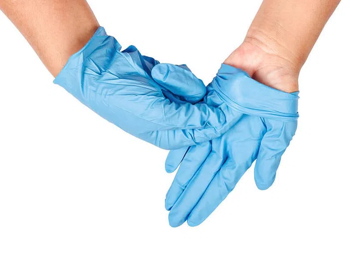 Hand throwing away blue disposable gloves medical, Isolated on white background, Save clipping path. Infection control concept.