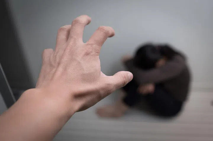 woman sit on floor with domestic violence