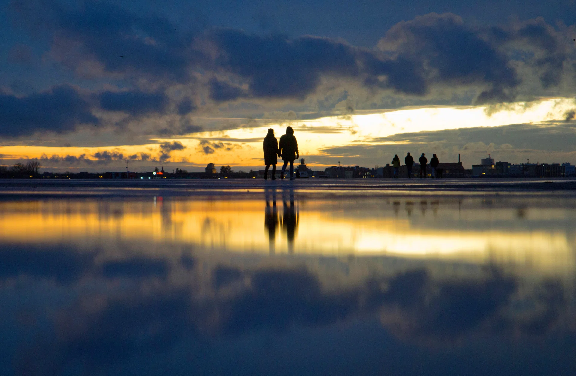 18 February 2022, Berlin: A couple walks across Tempelhofer Feld at sunset. Photo: Hauke Schröder/dpa-Zentralbild/ZB (Photo by Hauke Schröder/picture alliance via Getty Images)