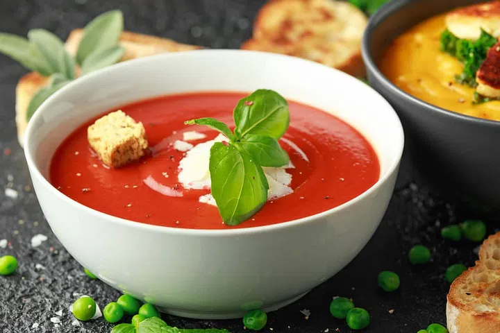 Tomato and fresh basil soup with garlic, cracked pepper corns, served with parmesan cheese, toast bread.