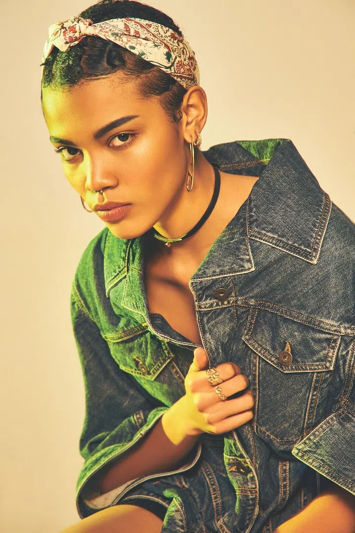 Denim oversized jacket with asymmetrical hemline, Loewe. Leather choker with Kelly gold-plated clasp, Chaine D’ancre gold- plated earrings, and assorted gold-plated rings, Hermes. Silk scarf (worn as headband), Longchamp