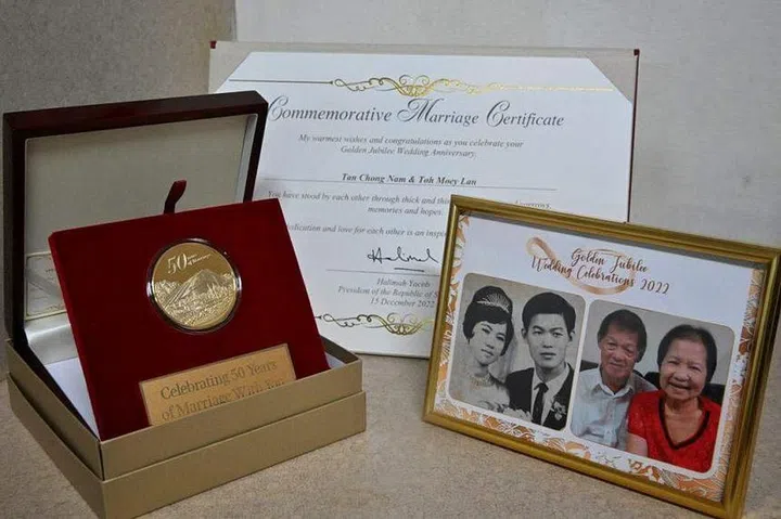 The commemorative marriage certificate and souvenirs that Mr Tan Chong Nam and Madam Toh Moey Lan received at the Golden Jubilee Wedding Celebrations. ST PHOTO: CHONG JUN LIANG