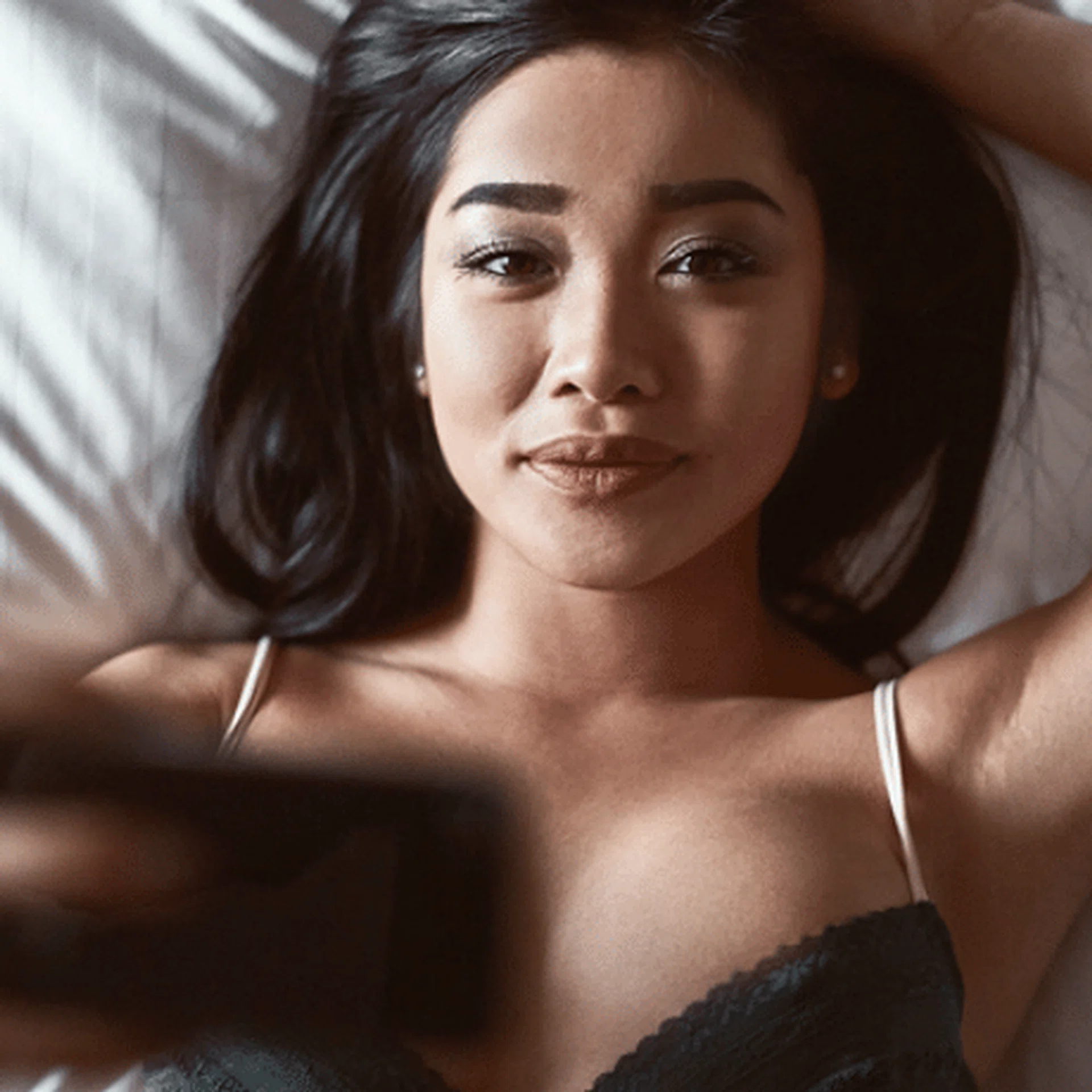t_beautiful-sensual-asian-woman-in-underwear-lying-on-the-bed-with-the-phone-in-his-hand