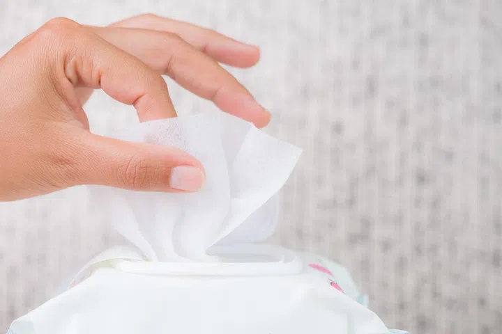 Closeup woman hand holding wet wipes from package. healthcare, people and medicine concept.