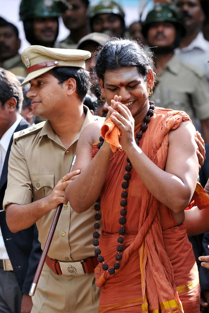 Controversial Hindu Godman Swami Nityananda gestures after appearing for his bail plea at the judicial magistrate court at Ramanagar District, some 50 kms from Bangalore, on June 14, 2012. A popular Indian guru facing a series of assault and sexual abuse charges was in police custody June 14 after he turned himself in to court authorities. Police ordered Swami Nithyananda, 35, to be detained for questioning after five women accused him of abusing them at his Hindu religious retreat in the southern state of Karnataka. AFP PHOTO/ Manjunath KIRAN (Photo by Manjunath Kiran / AFP)