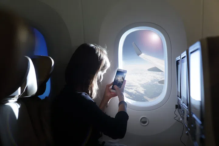 girl looking out of plane window