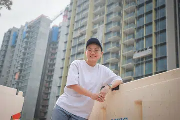 ST20260422_202641200896/jlyoung/Joyce Lim/Jason Quah

Teri Tan, 32, who bought a unit at Pinetree Hill (background), pictured April 22, 2026. ST PHOTO: JASON QUAH