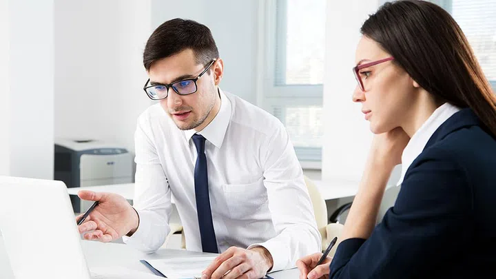 Businessman explains to colleague a new project in the modern office