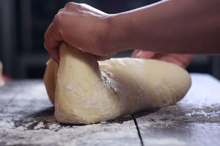 Close up image of bakery chef making bread dough in the kitchen