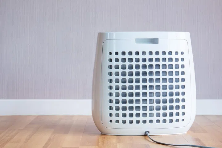 Modern portable air purifier in the room close up.