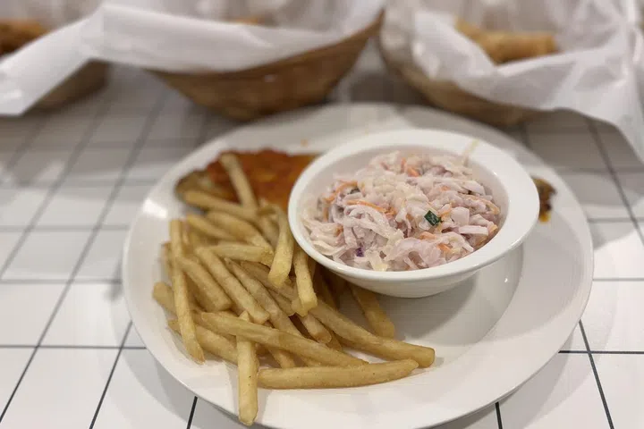 The grilled fish with sambal, fries and coleslaw is part of the lunch menu.