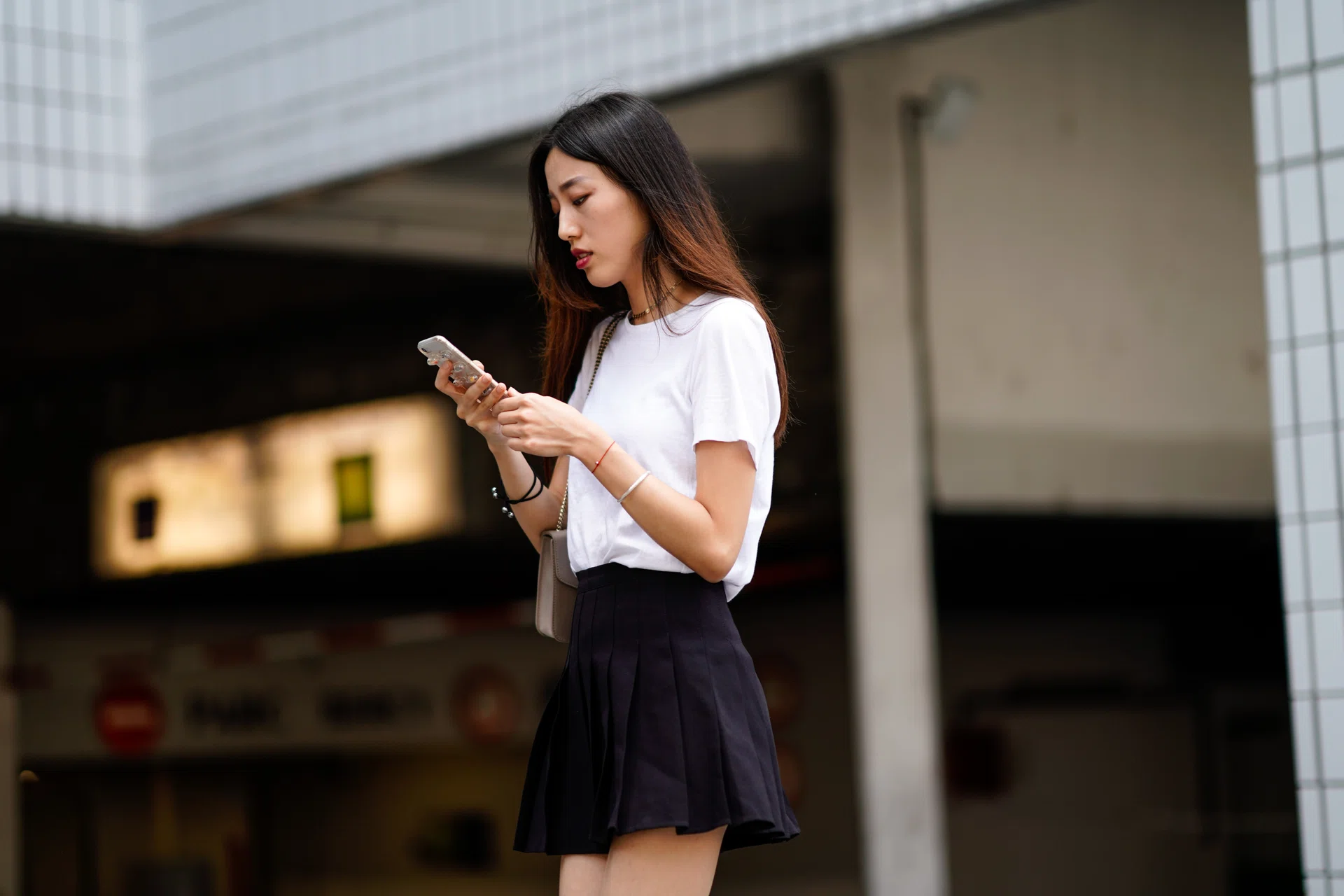 PARIS, FRANCE - JUNE 20:  A guest wears a white t-shirt, a black pleated skirt, outside Acne, during Paris Fashion Week - Menswear Spring-Summer 2019, on June 20, 2018 in Paris, France.  (Photo by Edward Berthelot/Getty Images)