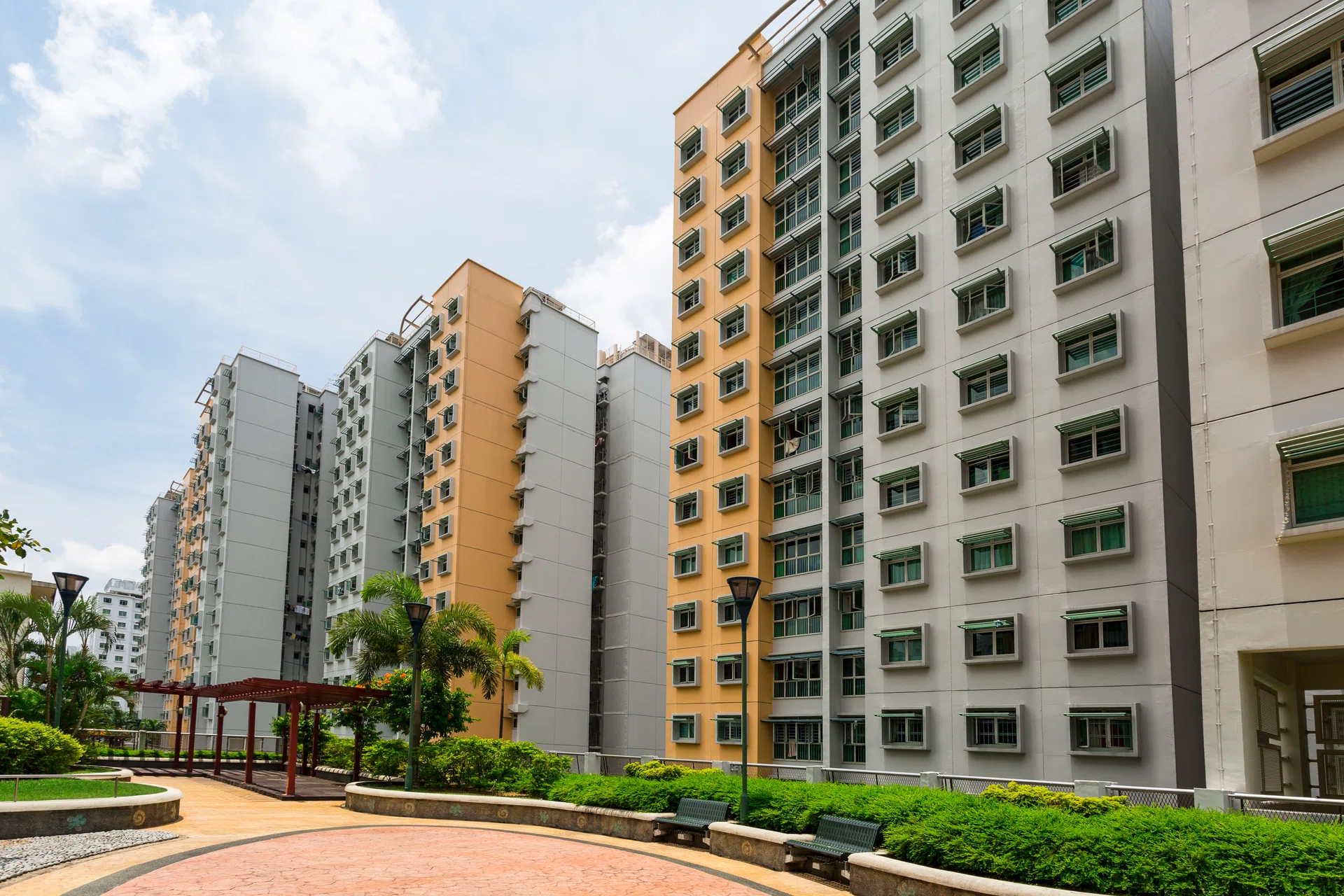 A park with trees and bushes leading to a New estate.