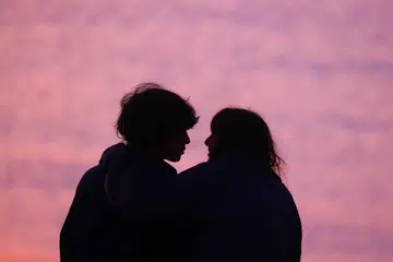 A couple is seen at Charles Clore Beach during a sunset at the Mediterranean Sea in Tel Aviv, Israel on December 30, 2022. (Photo by Beata Zawrzel/NurPhoto via Getty Images)