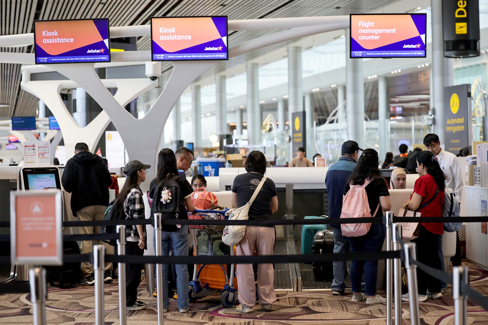 Passengers queueing at the Jetstar Asia check-in counter in Changi Airport Terminal 4 on June 11, 2025.