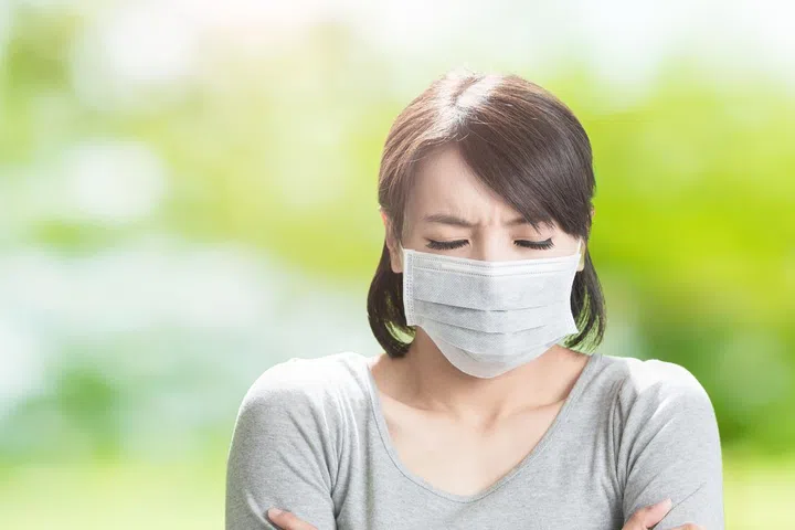 woman get sick and feel cold on the green background