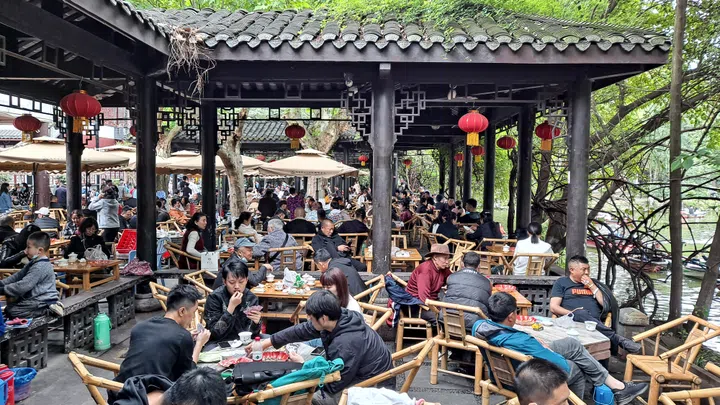 Chengdu, China - Apr 15, 2021: People drinking tea and chatting in tea house in People's Park in Chengdu, China.