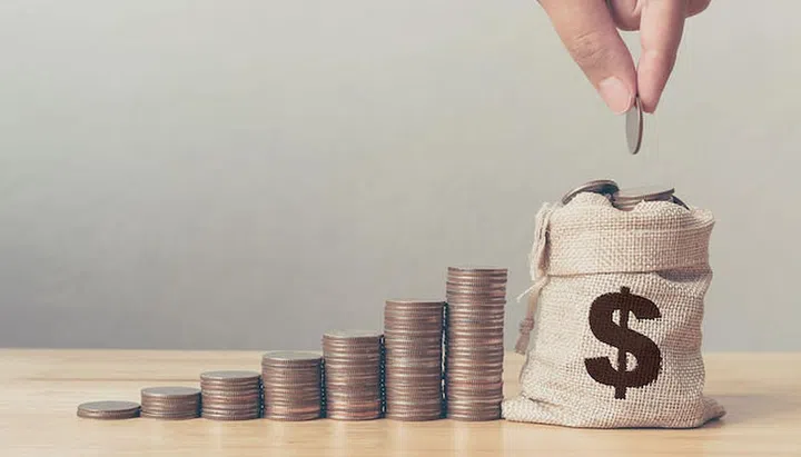 Hand of male or female putting coins in money bag with coin stack step growing growth saving money, Concept finance business investment