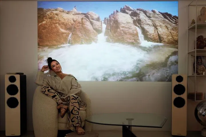 For a better movie experience, Phillips opted for a projector. She wears her own outfit including a top by JACQUEMUS, trousers by COS and sandals by LRNCE.Photo: Gan