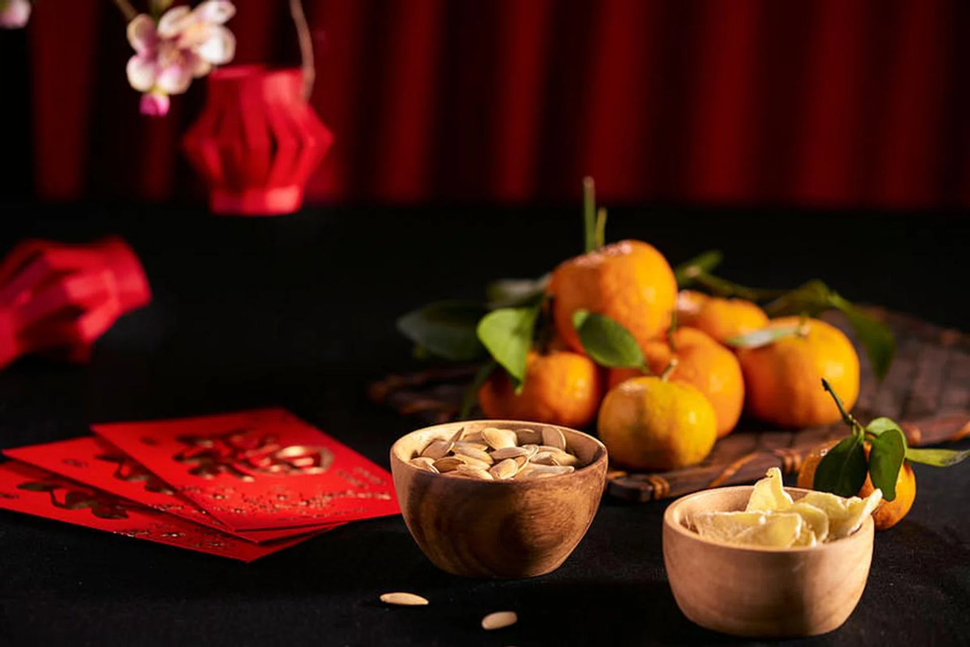 Concept image of the lunar new year - mandarin orange, jam and red packet. Text on envelop means Happy New Year and Happiness.